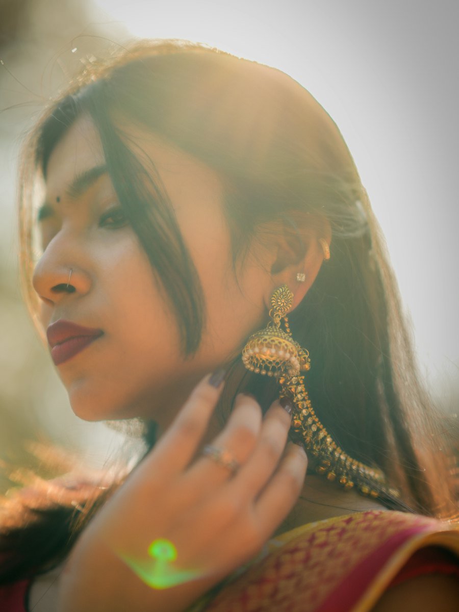 Woman in a sari wearing large ornate gold earrings