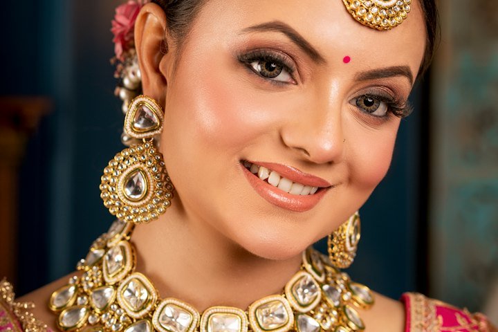 Smiling bride adorned in traditional gold jewelry